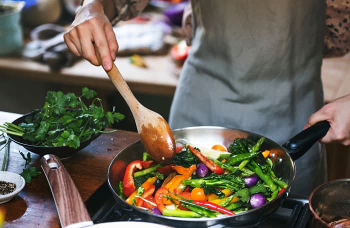 Person cooking a vegetable stir fry