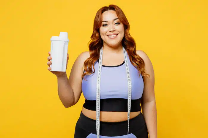 Happy person holding protein shake