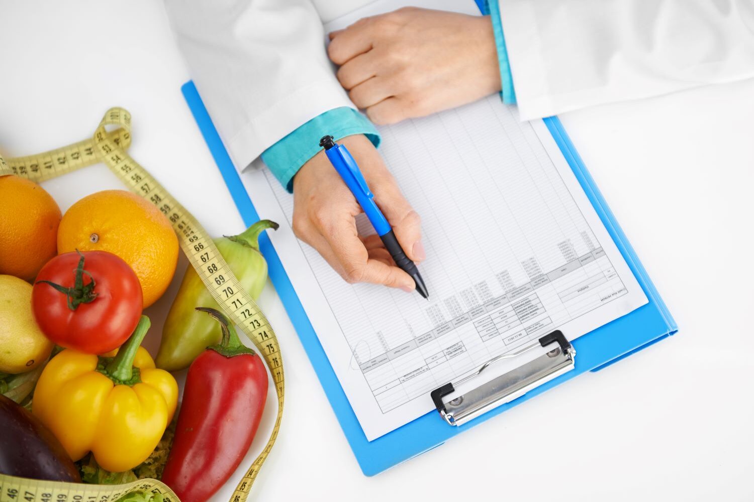 person filling out dietary log sheet